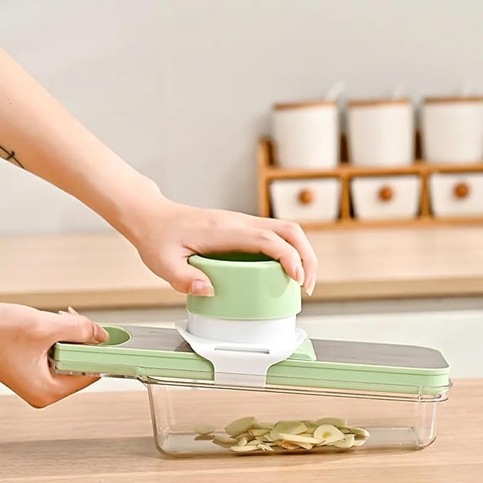 Multipurpose Compact Kitchen Mandoline Vegetable Slicer, Cutter, Cabbage Shredder, Cheese Shredder, with Container. Includes a Cut Resistant Glove & Super Sharp Potato Peeler. Stainless Steel Surface.